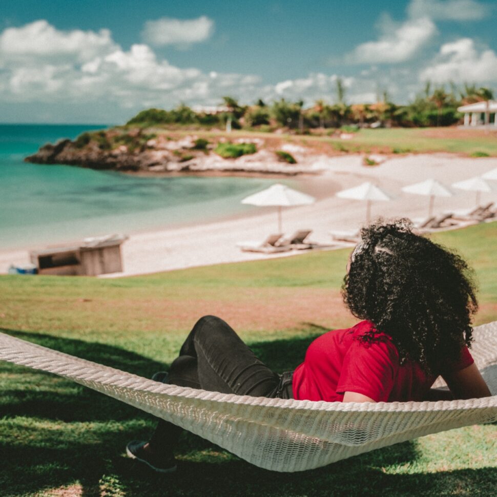 A woman lying on a hammock in Eleuthera, The Bahamas