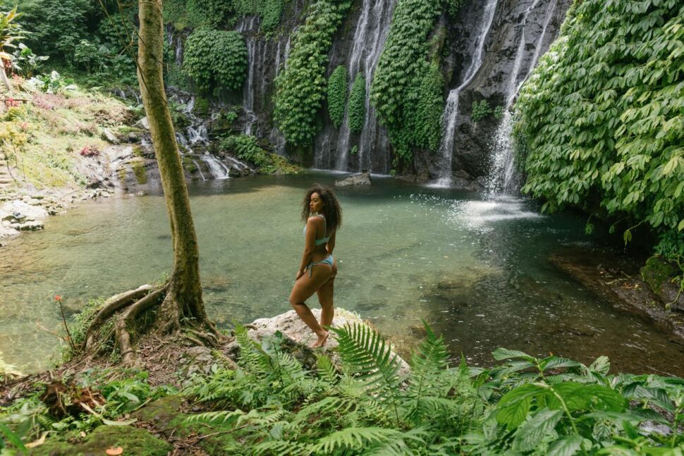 woman standing near waterfall in Bali