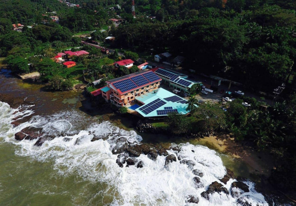 drone overheard shot of shoreline waves and rocks below the Hotel Playa Bonita in Limón