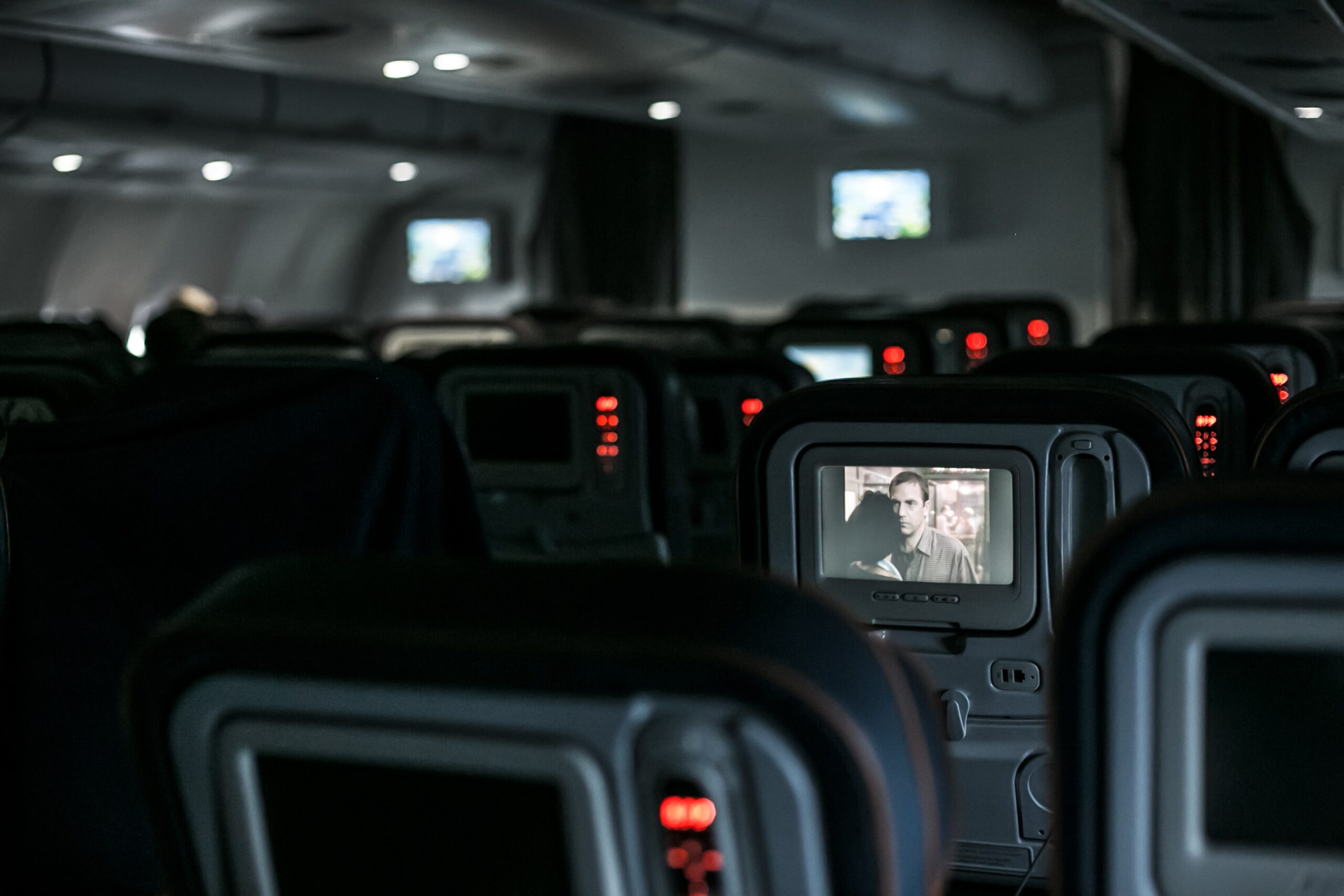 Check out the top rated airlines for safety, which offer the best precautions and quality. 
pictured: the interior of an airplane with passengers watching in-flight entertainment 