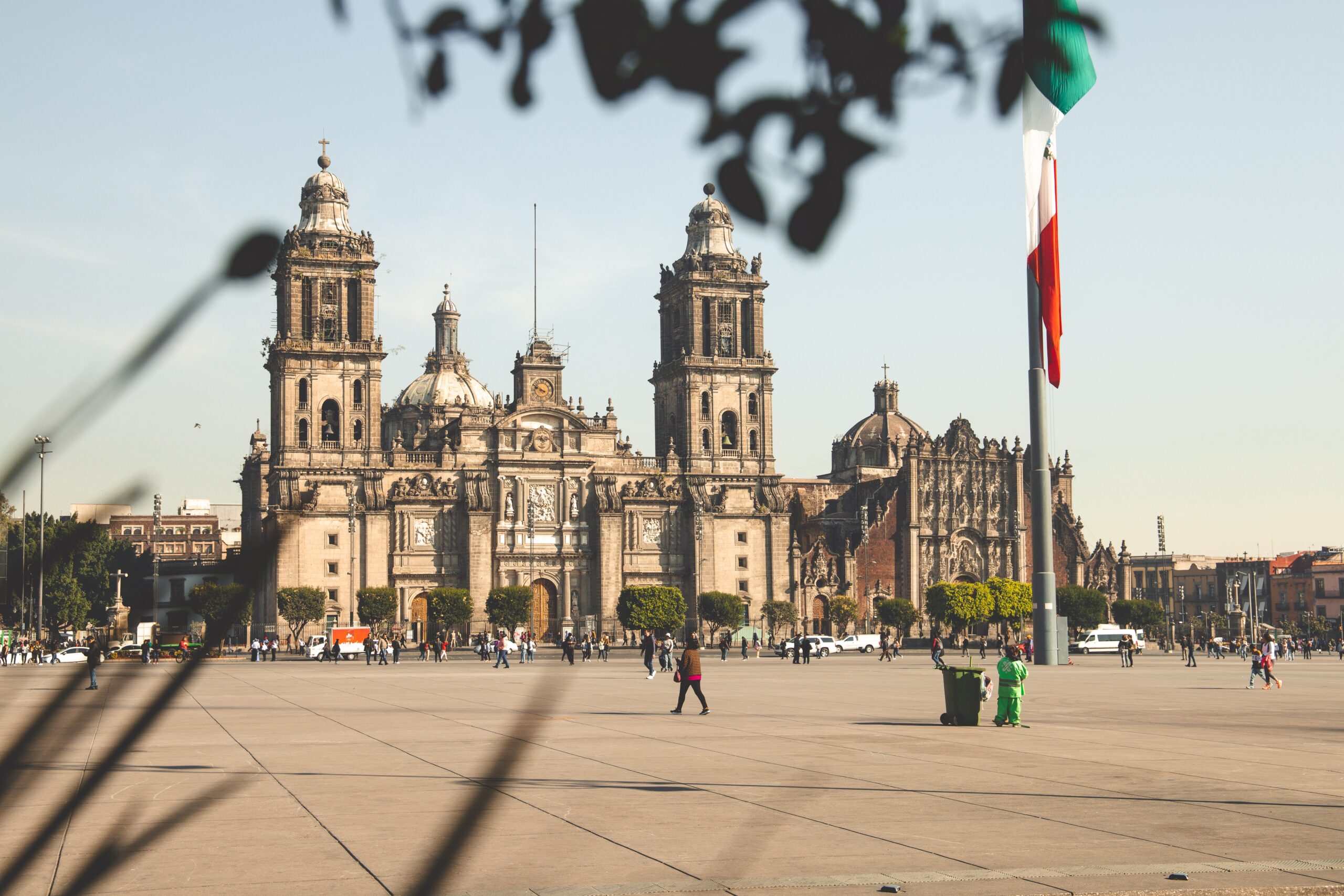 Read more about the best travel advisories to use when potentially traveling to areas that may not be fully safe. 
pictured: the bustling Mexico City with its national flag posted in front of a historical building