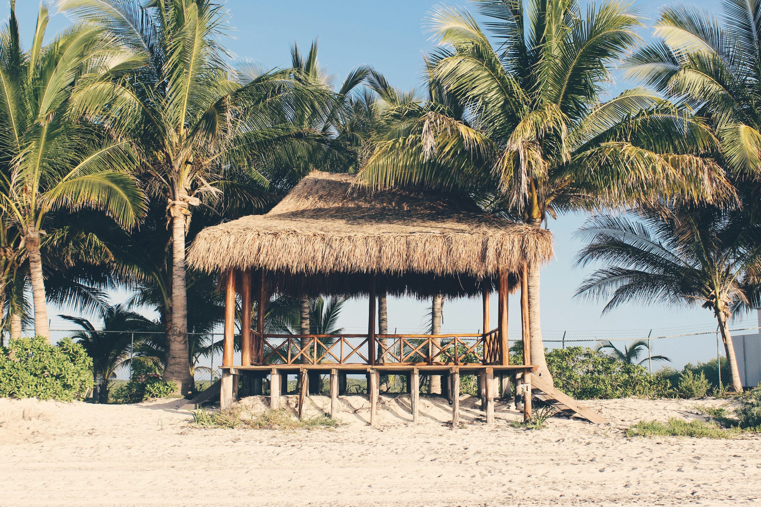 Check out these tips on staying safe while in Playa del Carmen.
pictured: a straw hut on a Playa del Carmen beach 