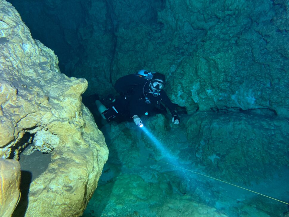 diver exploring underwater cave 