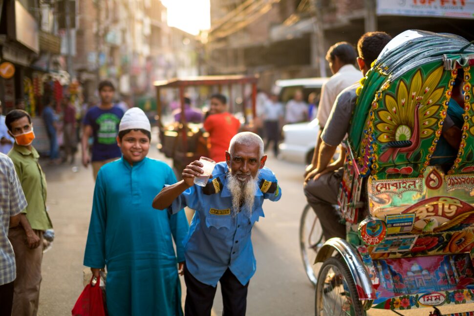 older man and boy walking through the streets of Bangladesh
