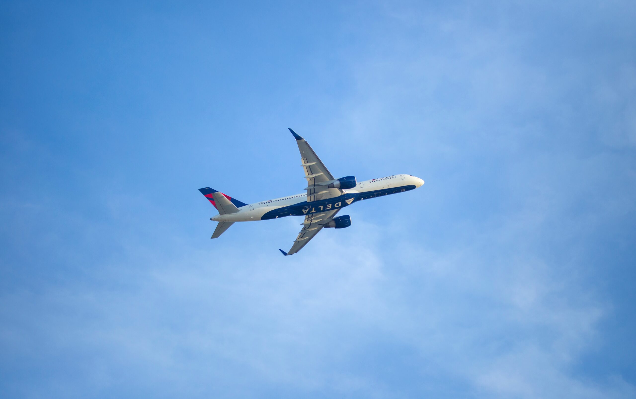 Delta is the best domestic airline that travelers can book. learn more about the airline's perks. 
pictured: a Delta airplane in the bright blue sky
