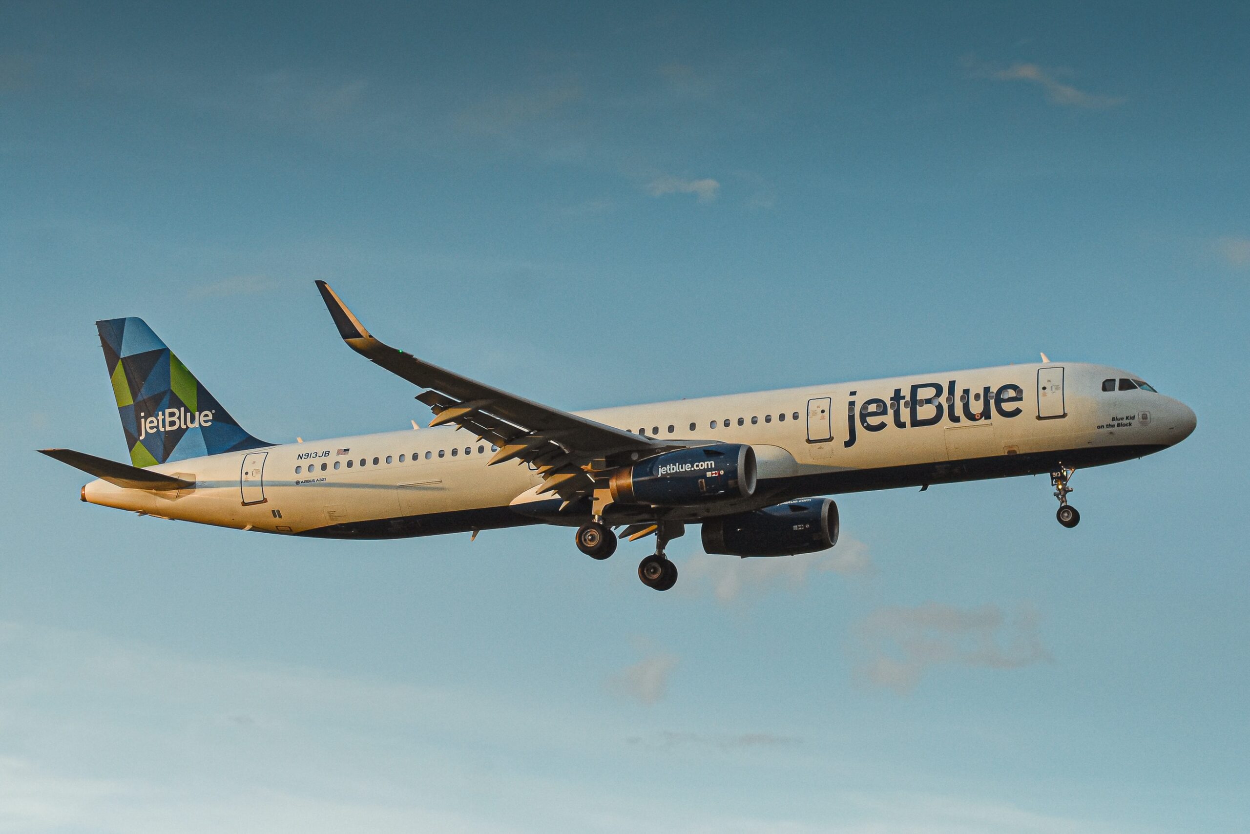 JetBlue has the highest quality in-flight environment and amenities. 
pictured: a JetBlue airplane in the air on a clear day
