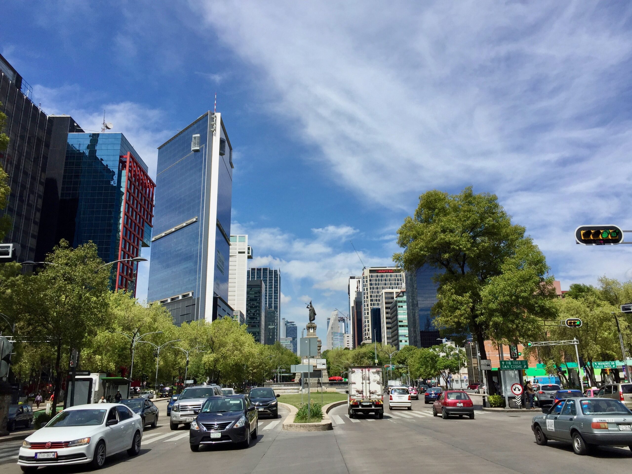 These techniques and tips will help travelers stay safe in Mexico City.
pictured: Mexico City on a bright clear day with cars passing by on the city street 