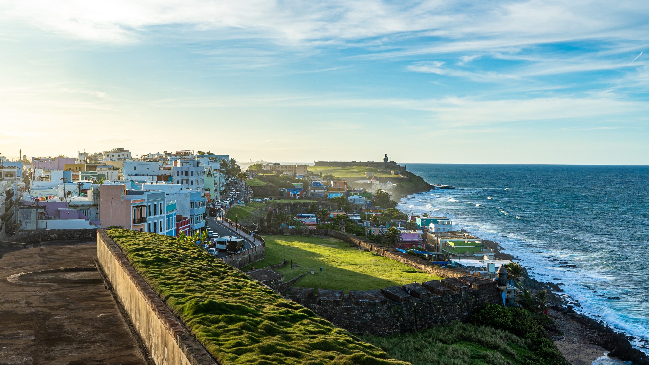Puerto Rico is a generally safe destination but here are ways for travelers to feel more secure. 
pictured: the lush green coast of Puerto Rico with crashing waves on the beach 