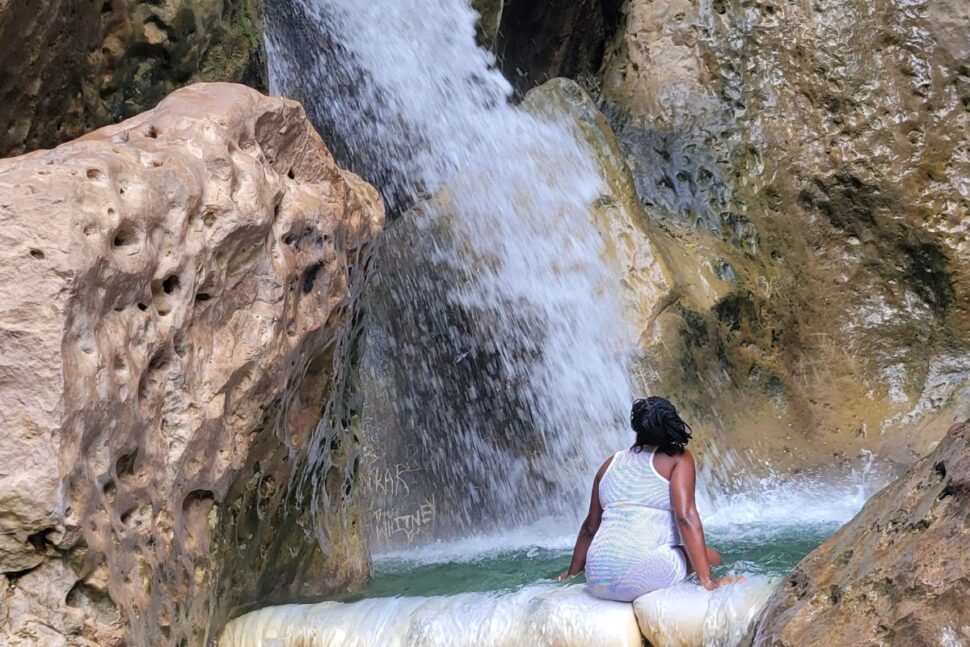 woman looking at Cane River Falls in Jamaica