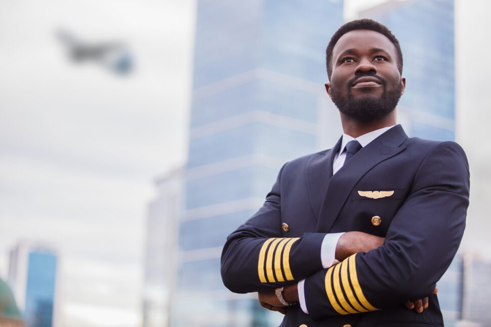 Man posing while wearing pilot uniform