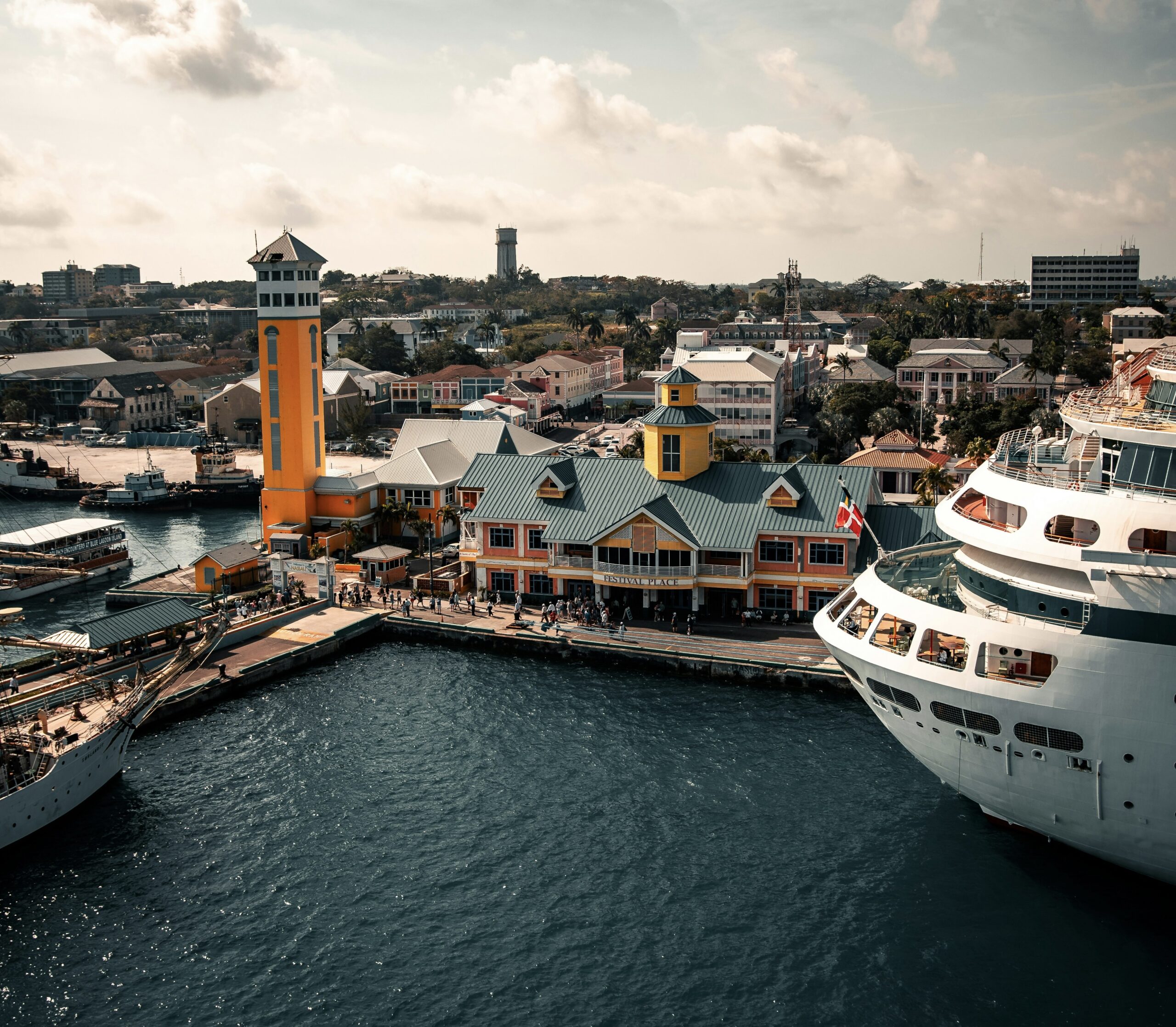 Learn more about how to get around one of the world’s most popular cruise ports. 
Pictured: Nassau’s cruise port with tourists walking around on the dock 