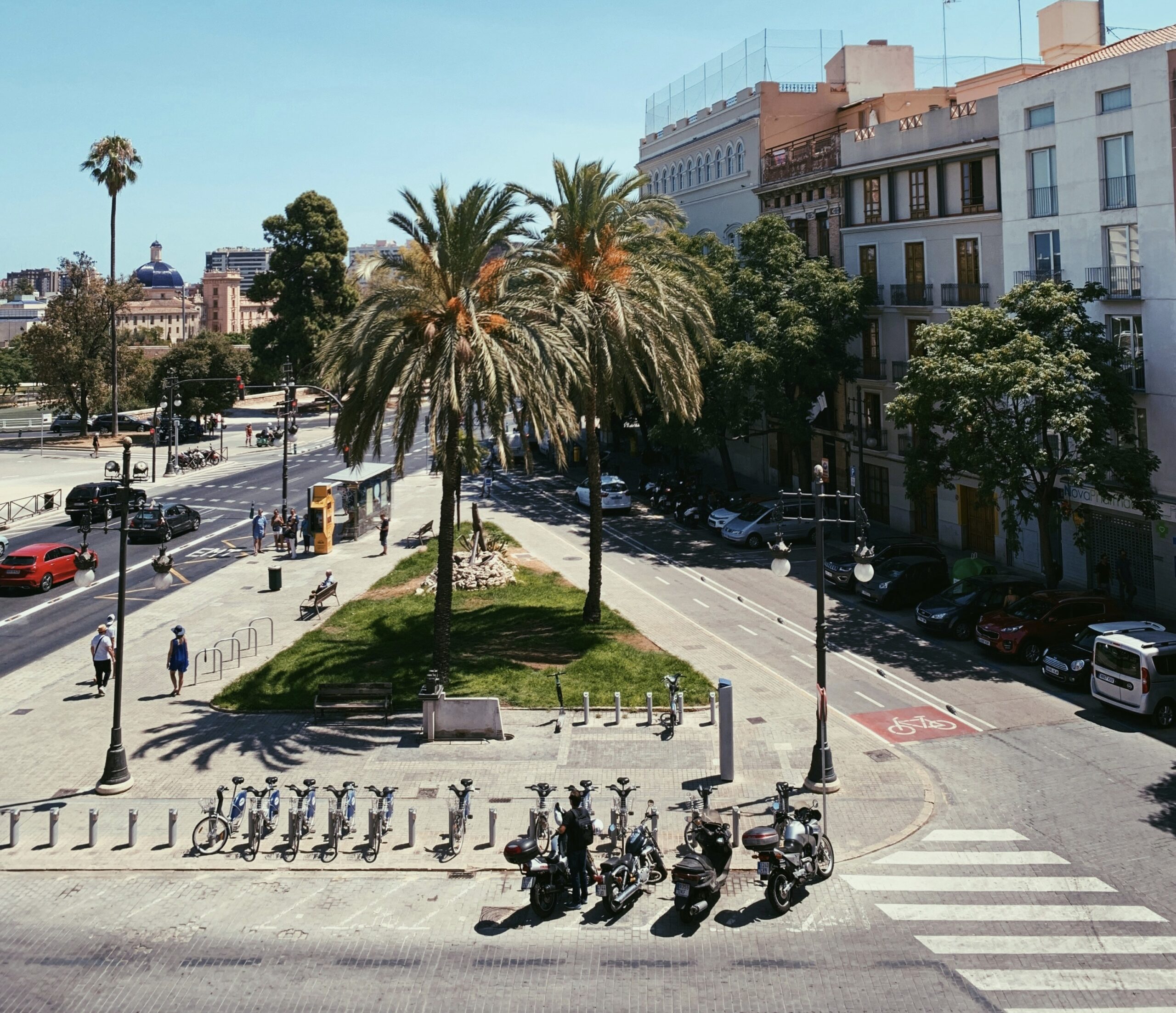 These two cities in Spain are quite popular. Learn more about how affordable each area is for tourists. 
pictured: a pedestrian area of Valencia, Spain during a clear sunny day 