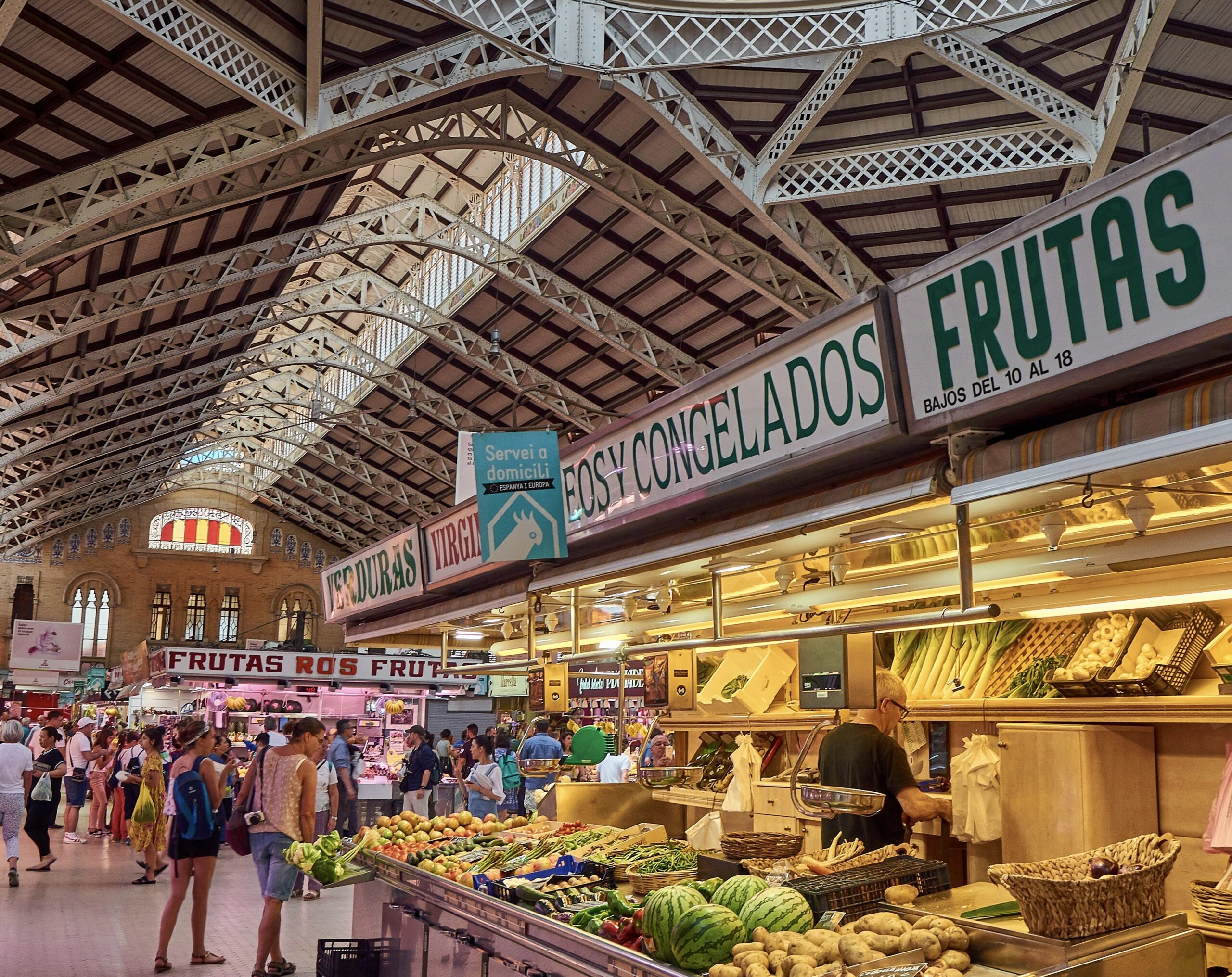 These popular things to do in Valencia and Barcelona are activities that tourists should not miss out on. 
pictured: the market of Valencia with locals and tourists perusing the avilable food