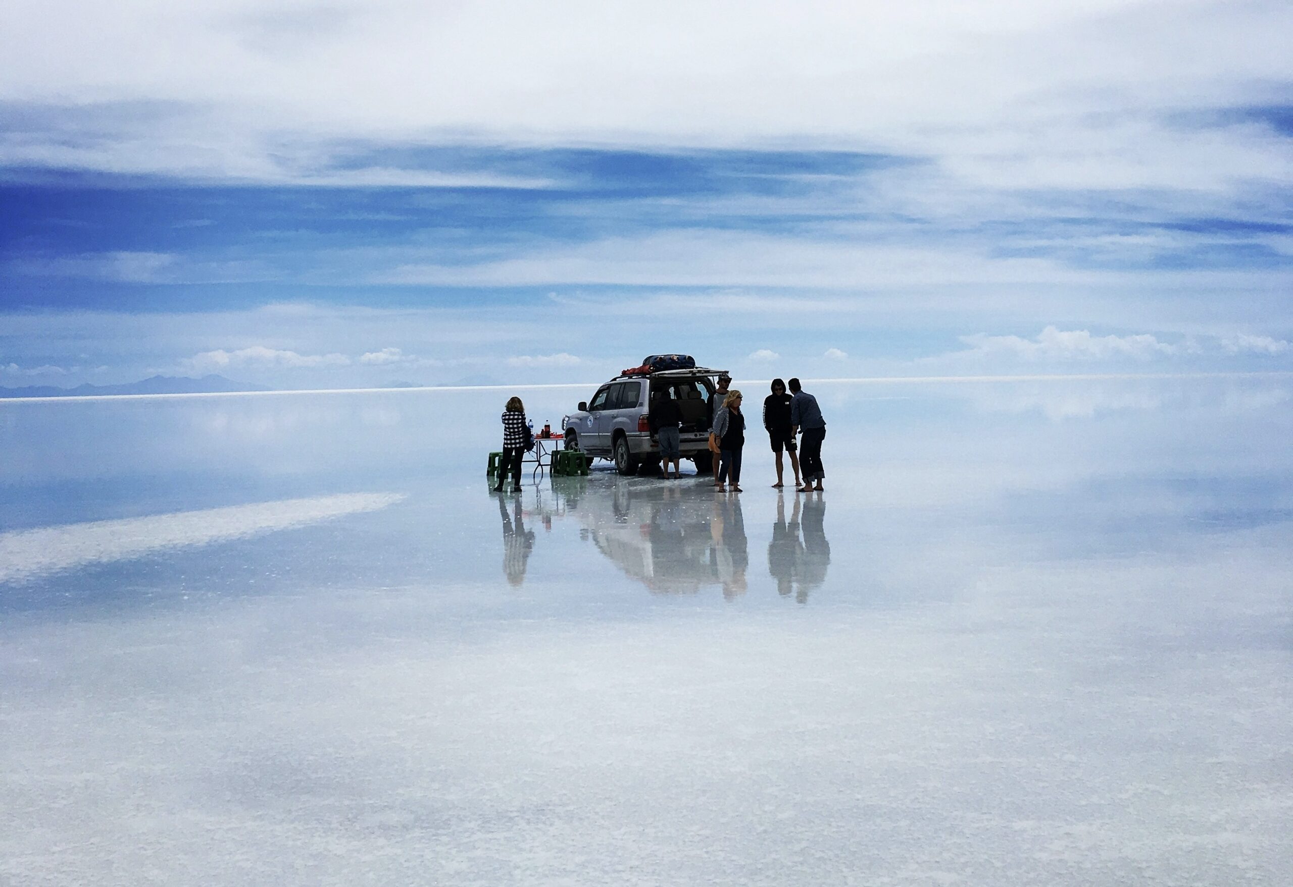 Check out the Uyuni salt flat experience and what travelers can expect. 
pictured: a Black family setting up to relax and enjoy the views of the Uyuni salt flat 