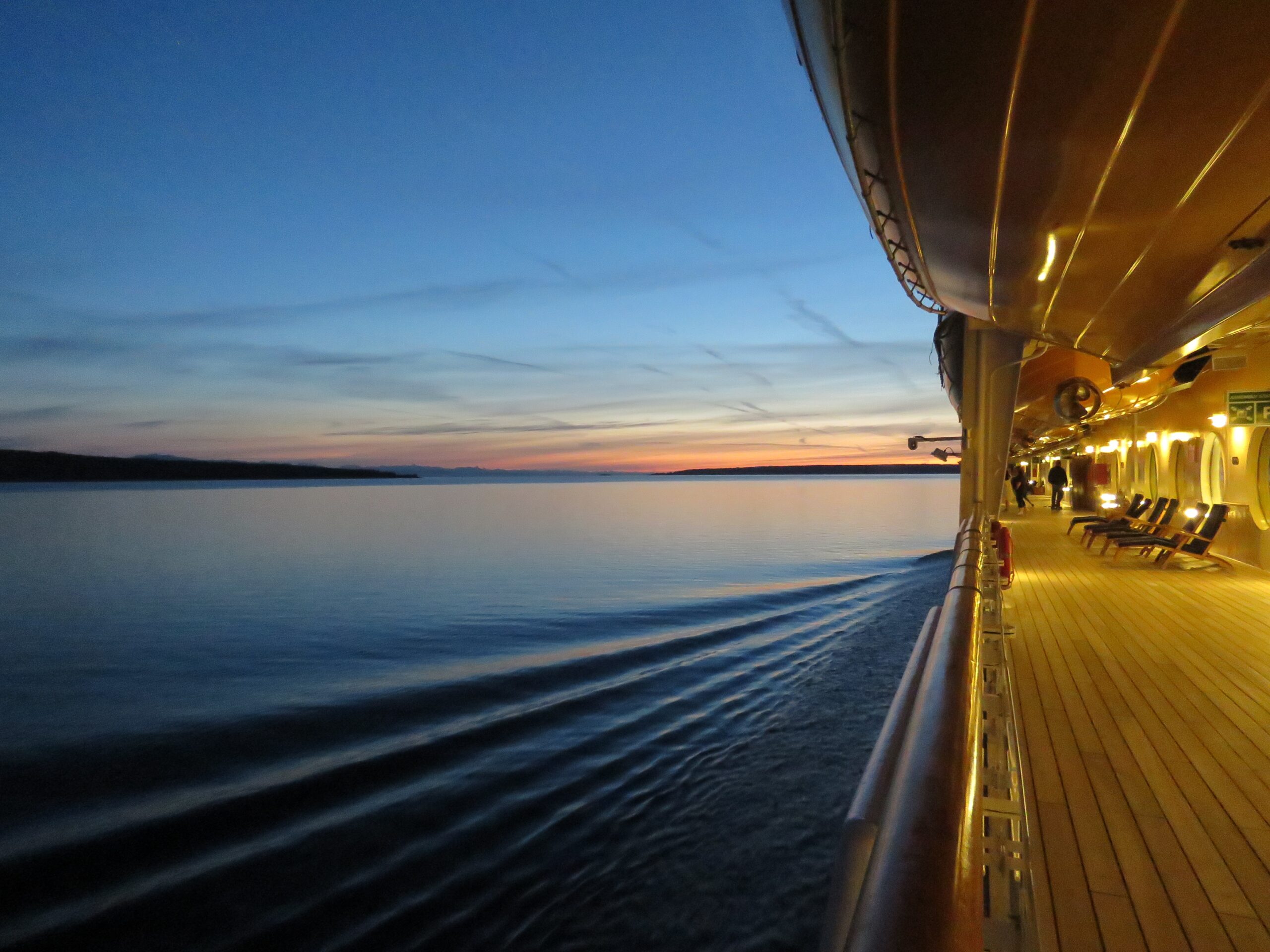 Learn more about the Margaritaville cruises that are available to travelers. 
pictured: a view from a cruise ship after sunset overlooking the sea
