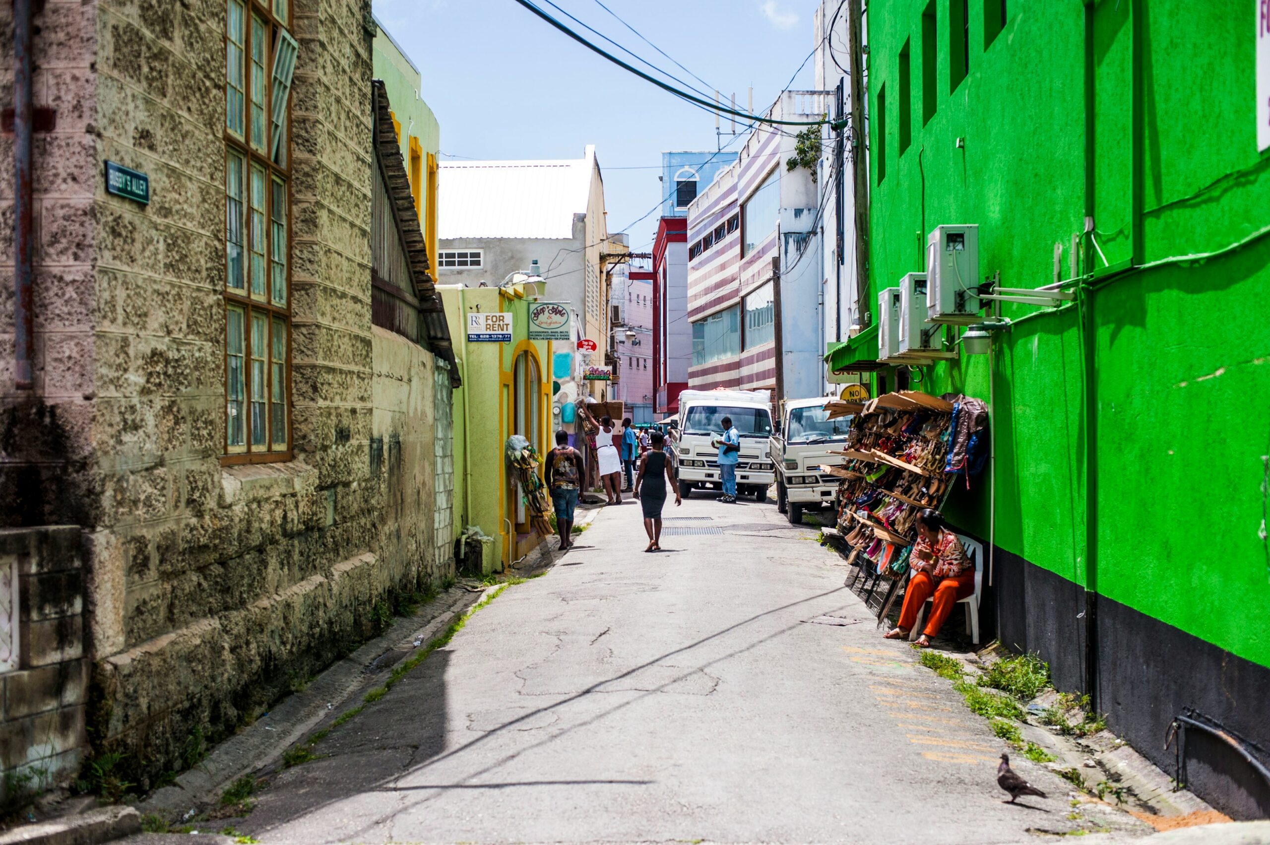 Learn more about the best ways for travelers to stay safe in Barbados.
pictured: a street in Barbados with locals 