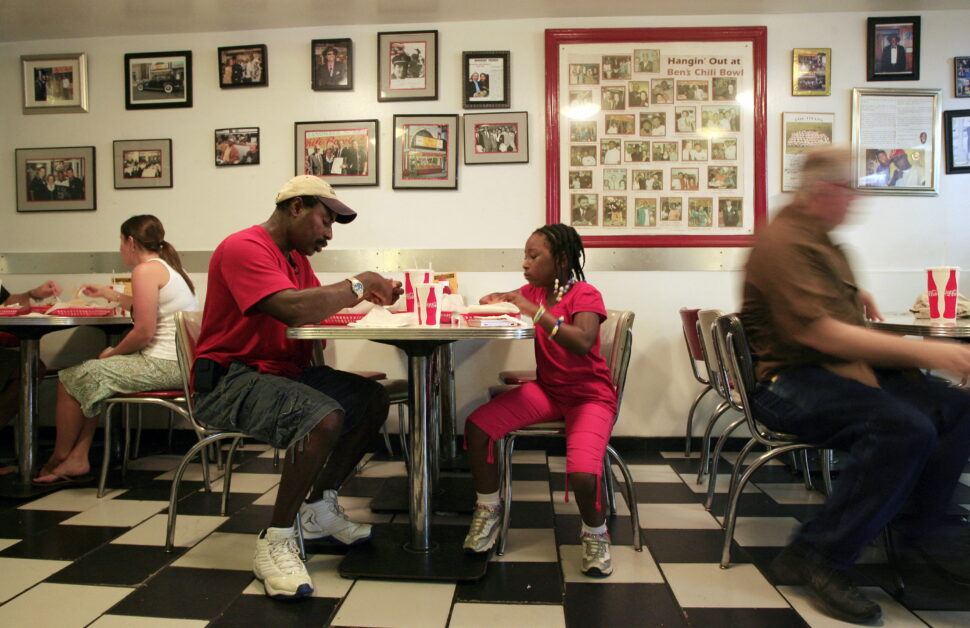 Reginald Lonon (2nd L) and his daughter, Alisha, eat lunch at Ben's Chili Bowl in Washington, DC, August 16, 2010. Ben's Chili Bowl has been serving half-smokes, hot dogs and chili since 1958 when owner Ben Ali opened the now iconic DC landmark and has had visits from celebrities and politicians, including US President Barack Obama, French President Nicolas Sarkozy and comedian Bill Cosby. The restaurant was one of the few to stay open on Washington's U Street corridor as riots swept the area following the assassination of Dr Martin Luther King Jr, in 1968.