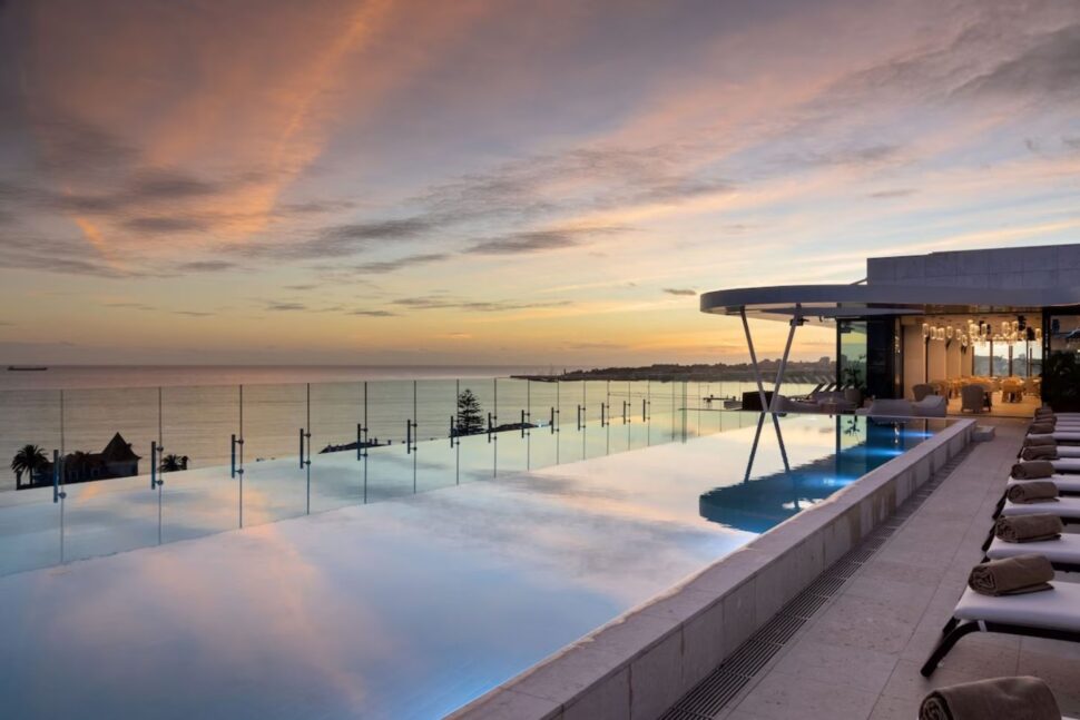 rooftop pool at EVOLUTION Cascais-Estoril in Portugal with ocean and sky views at sunset