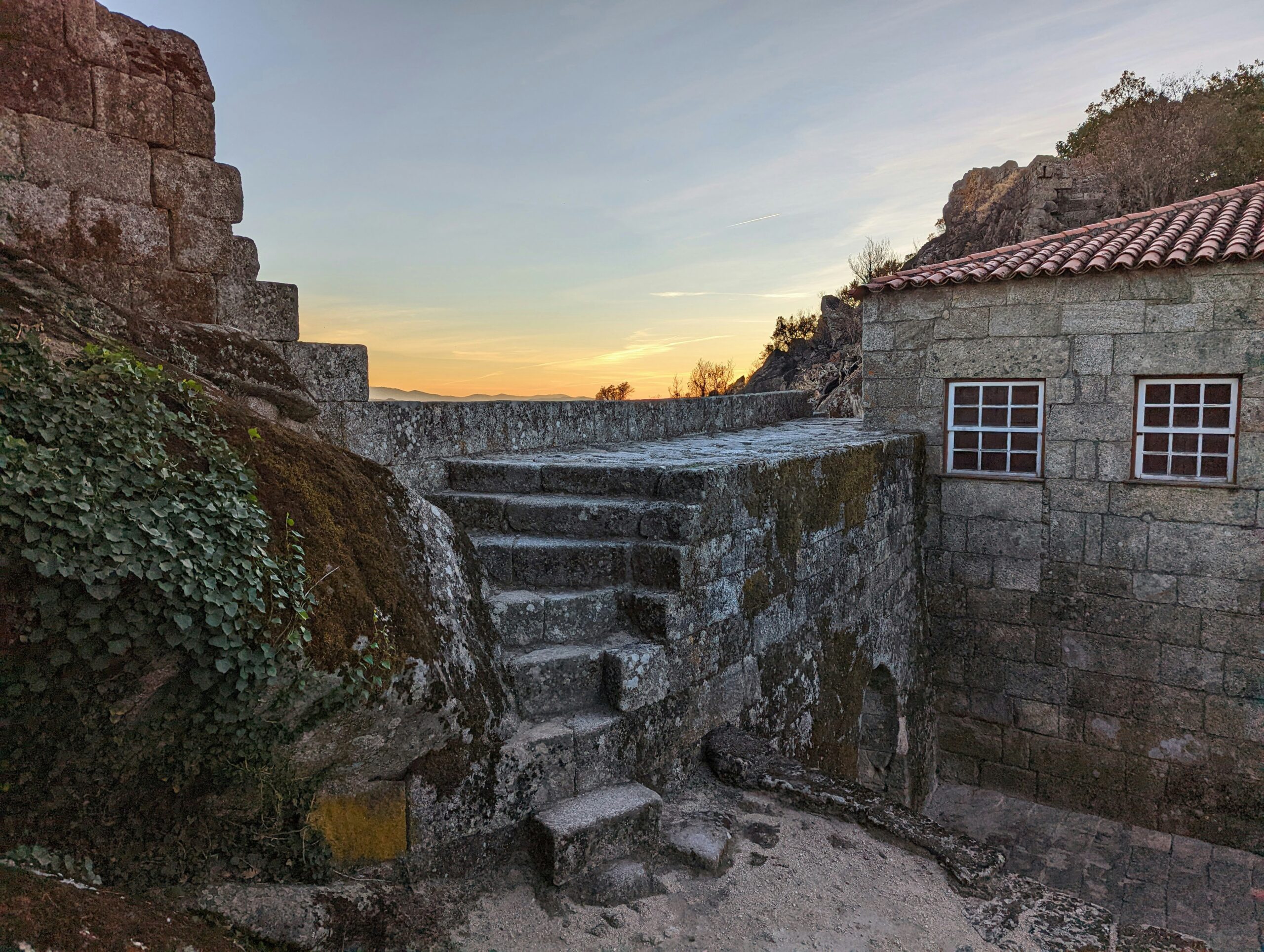 Many scenes of the movie Damsel were filmed in Portugal. Check out exactly where travelers can see the stunning views from the movie. 
pictured: an old staircase made of stones overlooking the mountains of Portugal. 