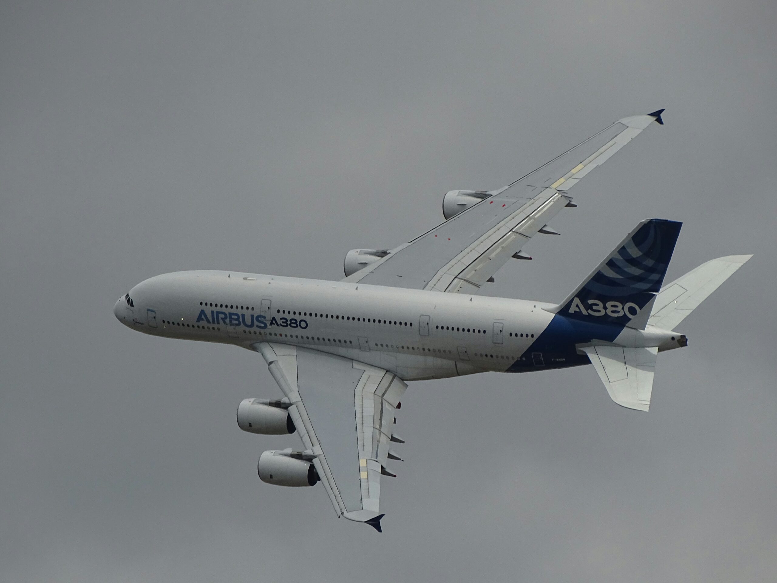 Learn more about the airplane production industry and other manufacturers. 
pictured: an Airbus plane flying on a cloudy day