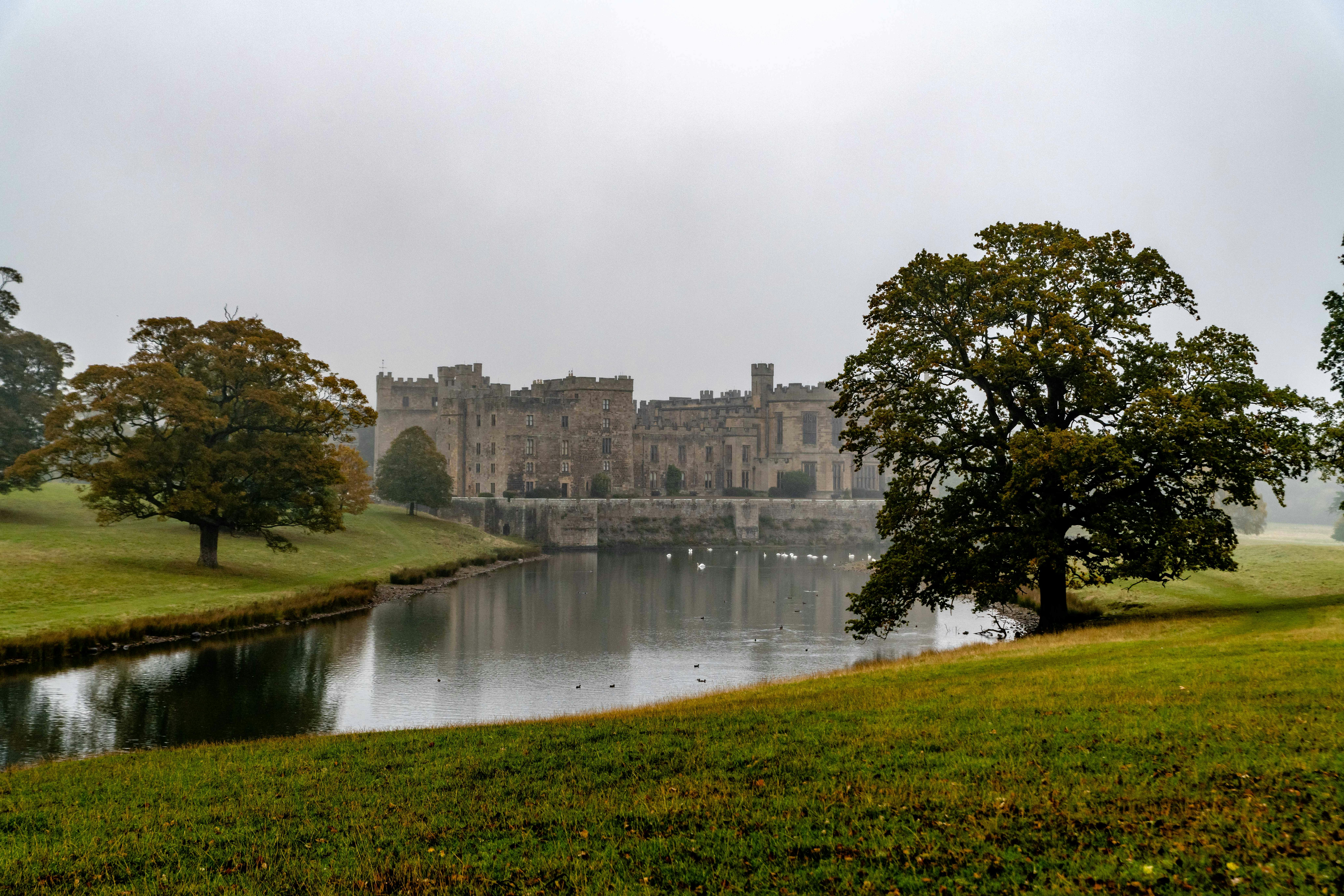 The countryside of England is home to one of the filming locations of the movie Damsel. 
pictured: an English estate with a large pond surrounding it 