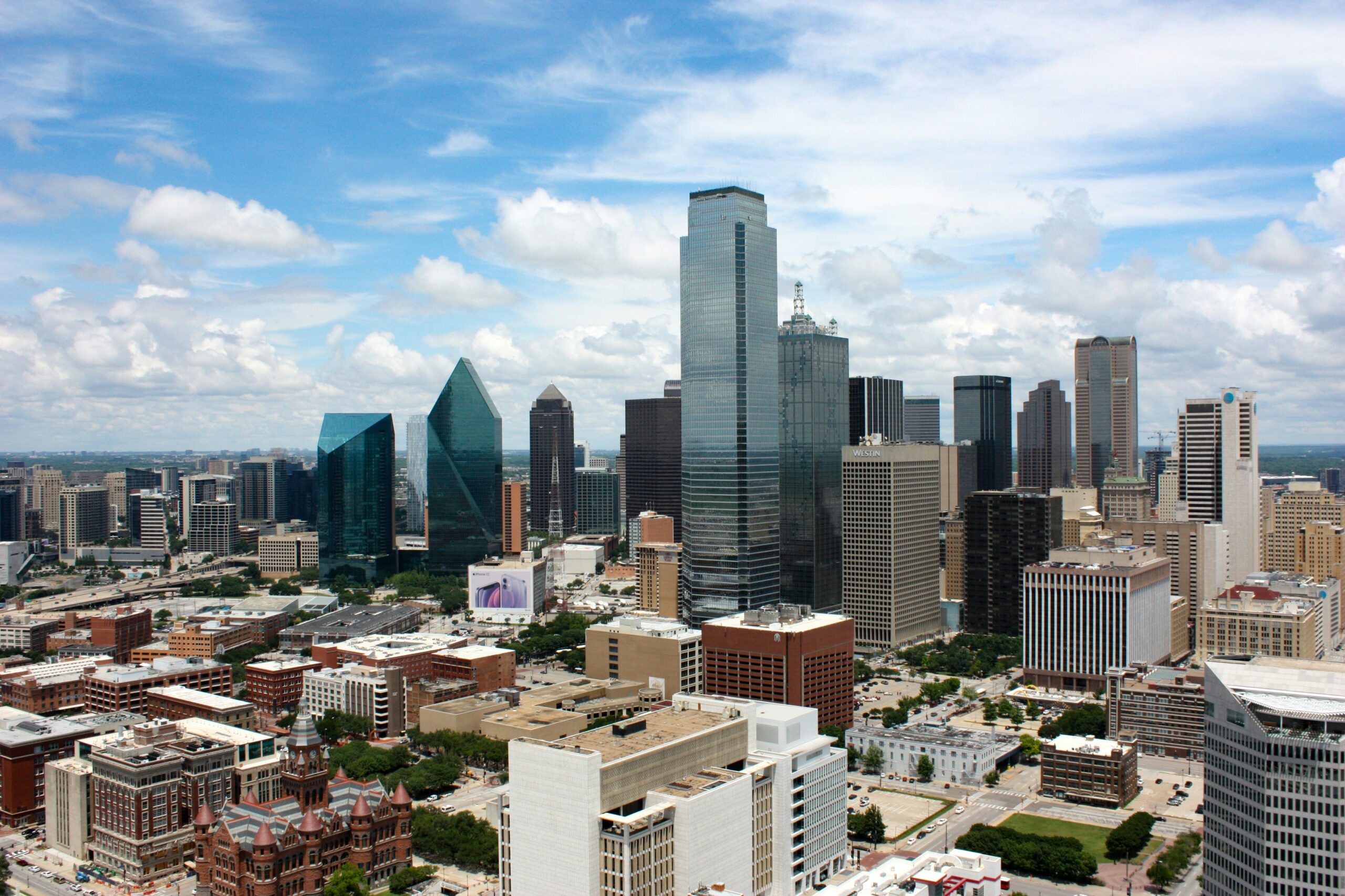 Check out the top destination for a road trip from Dallas. 
pictured: the cityscape of Dallas, Texas on a bright cloudy day 