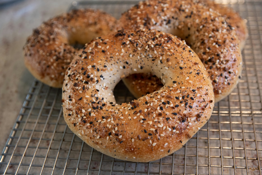 These bagel shops are some of the most popular spots to pick up a quick bagel in NYC. Pictured: a traditional bagel fresh out the oven
