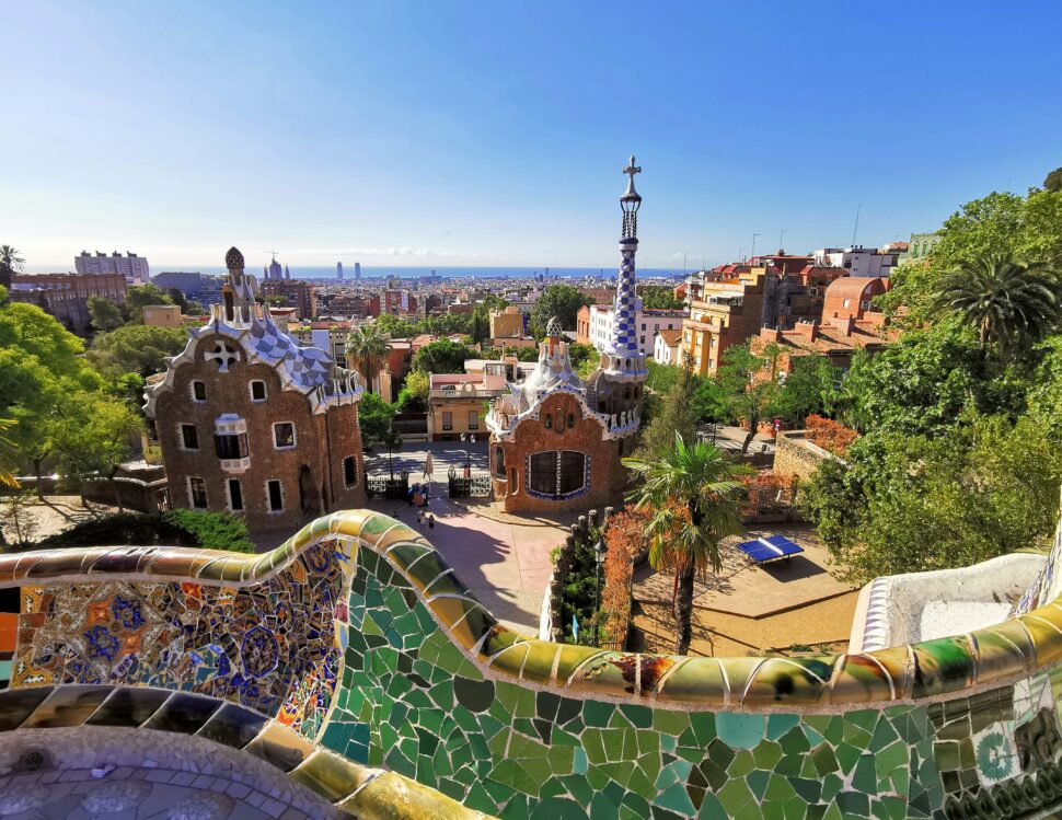 Learn more about how Barcelona is one of the cheapest places to visit in May. pictured: a view of Park Güell in Barcelona, Spain on a bright clear day