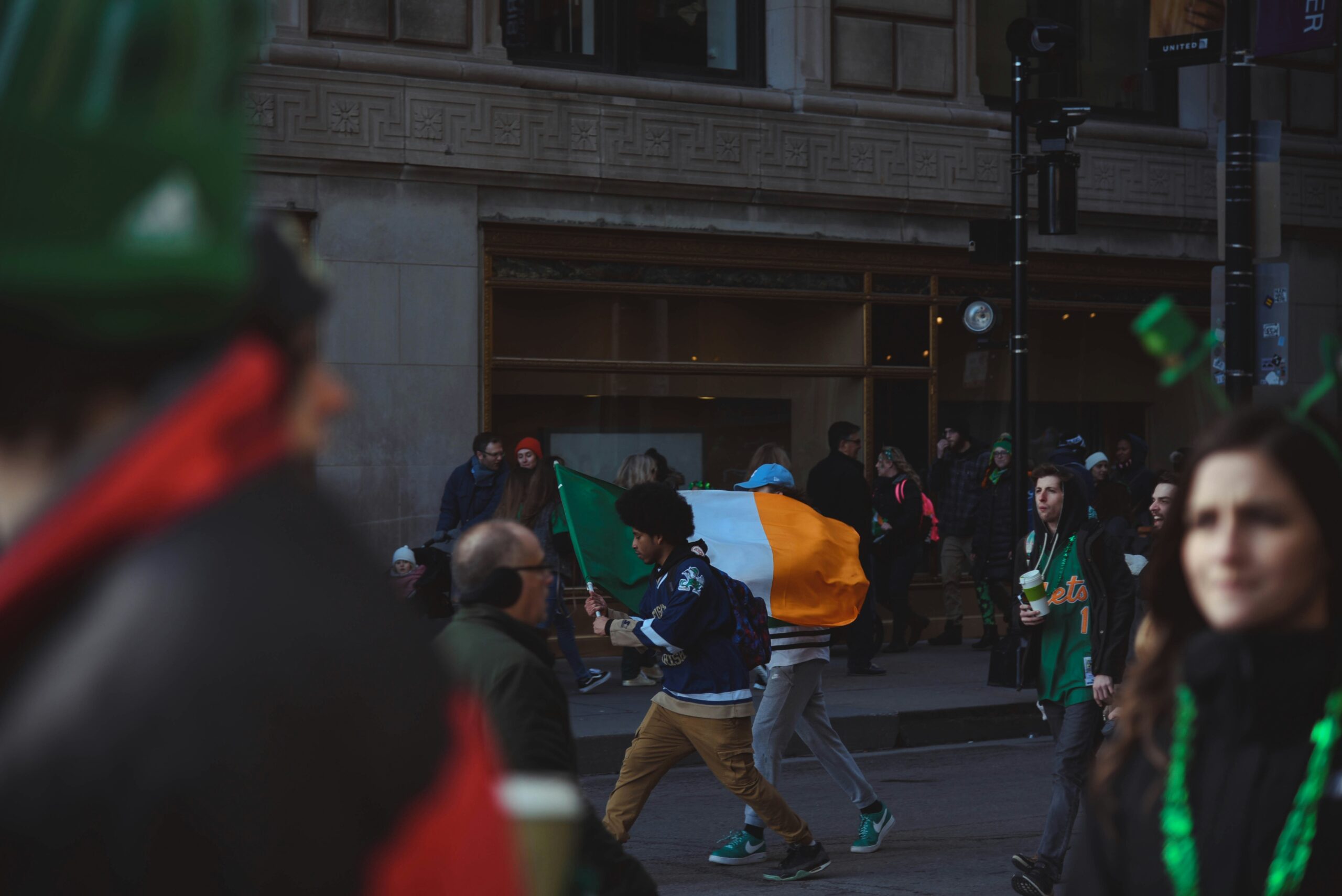 Learn more about how St. Patrick's Day is celebrated in New Orleans. 
pictured: a St. Patrick's Day parade with attendees celebrating in the streets