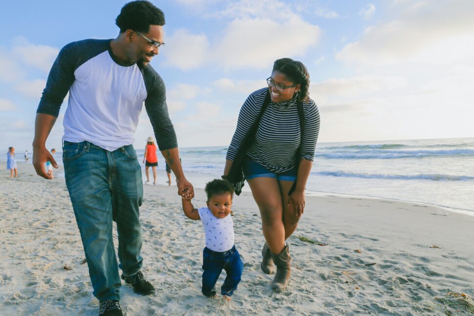 woman, man and child walking on the beach