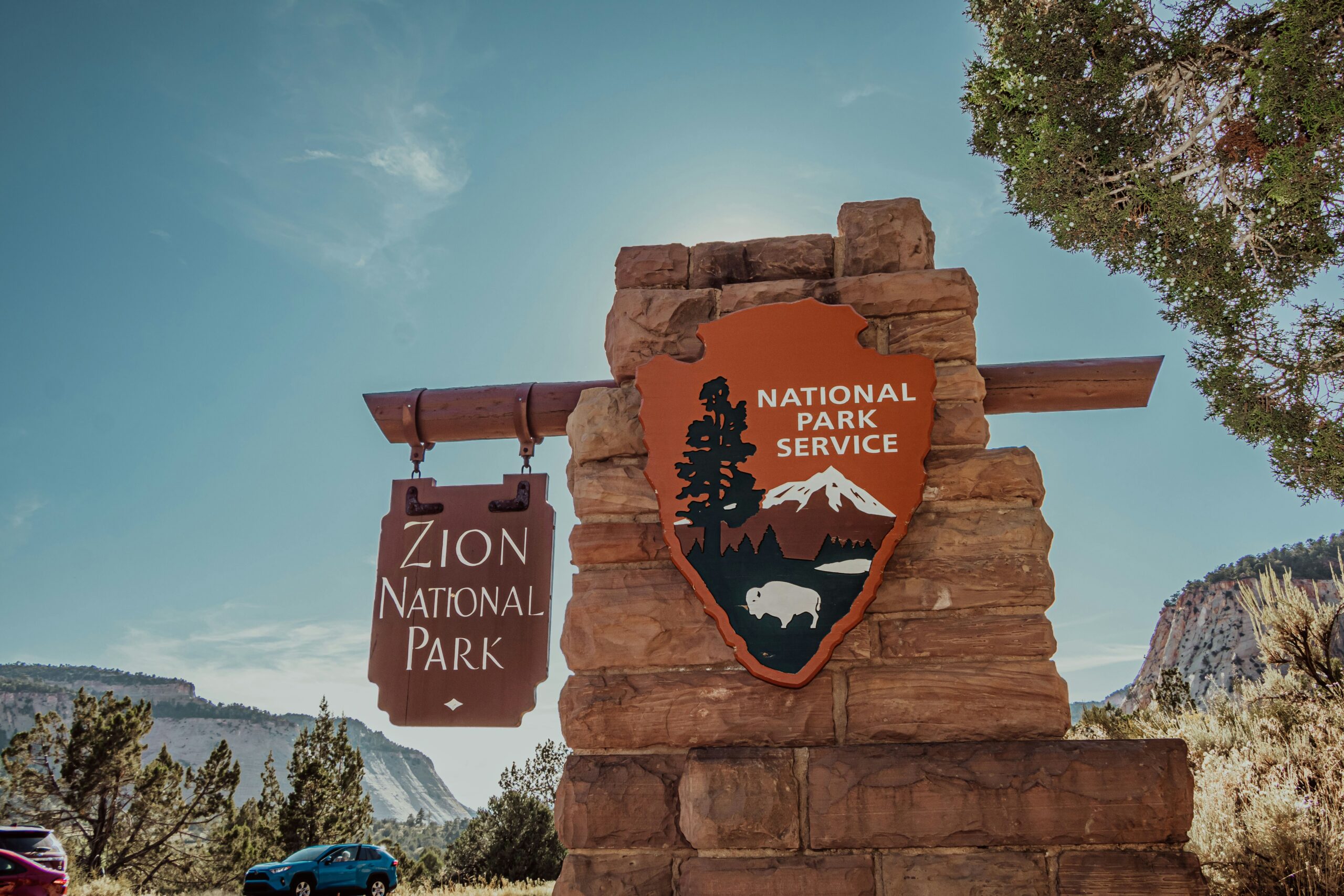 These national parks require visitors to maker a reservation during these peak times.
Pictured: the Zion National Park entrance sign 