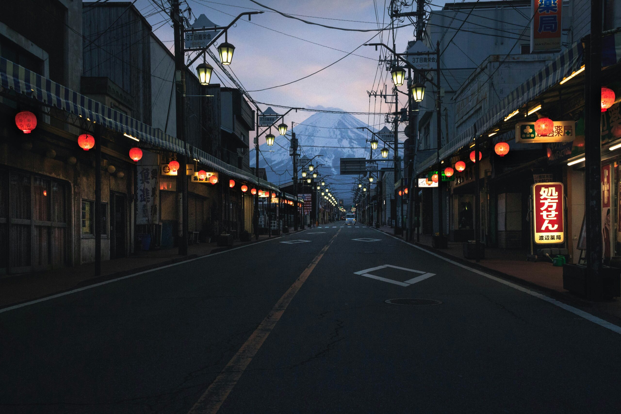 Learn about the issues that have led to a barrier at Mount Fuji. 
pictured: a town in the foreground of Mount Fuji