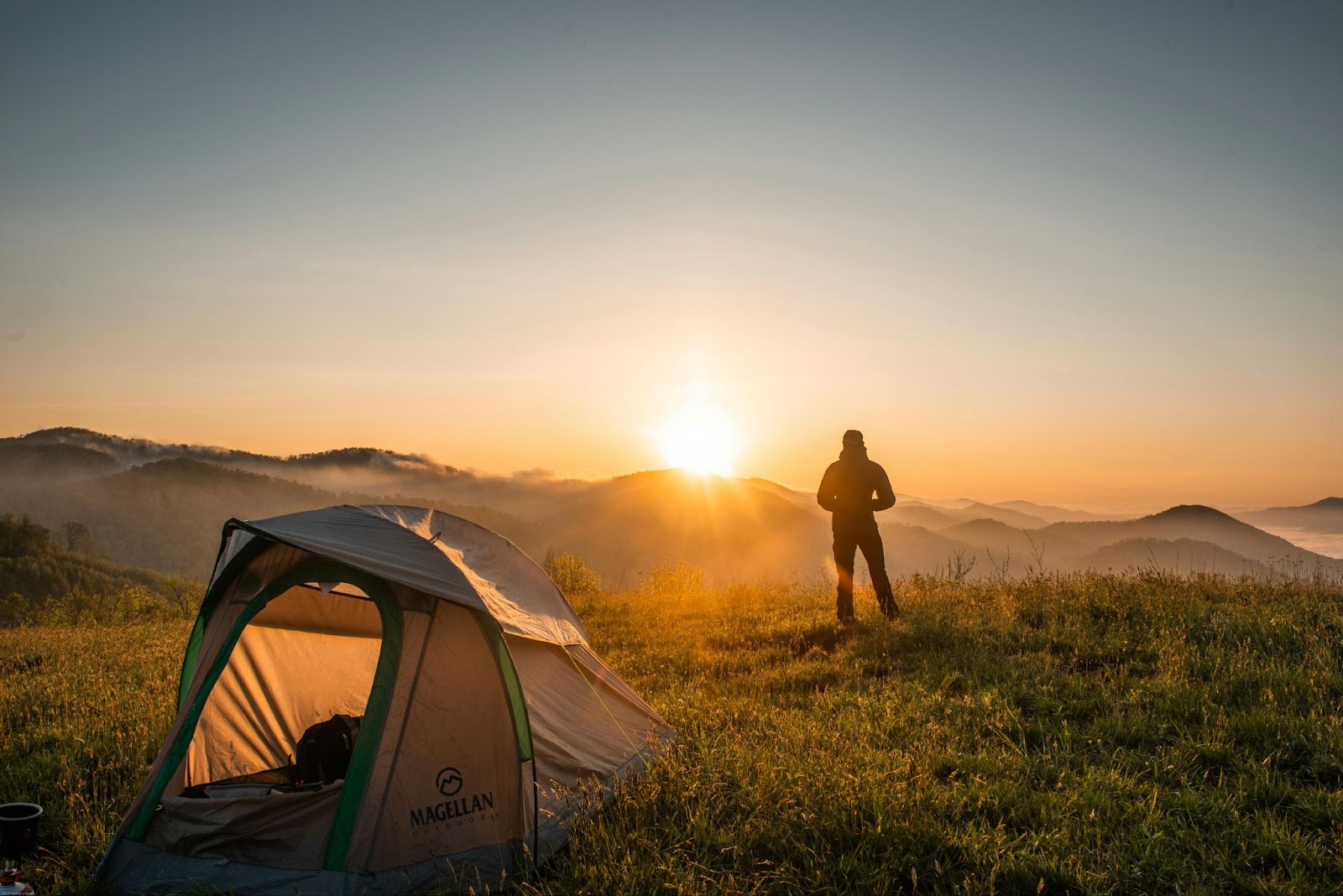 Camping is a great reason for September to be considered the best time to visit Montana. 
pictured: a man overlooking Montana while camping