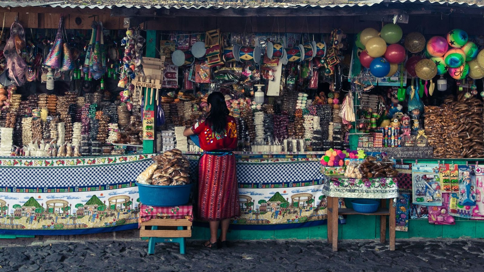Travelers can save money by visiting Guatemala during the dry season. 
pictured: a local market in Guatemala