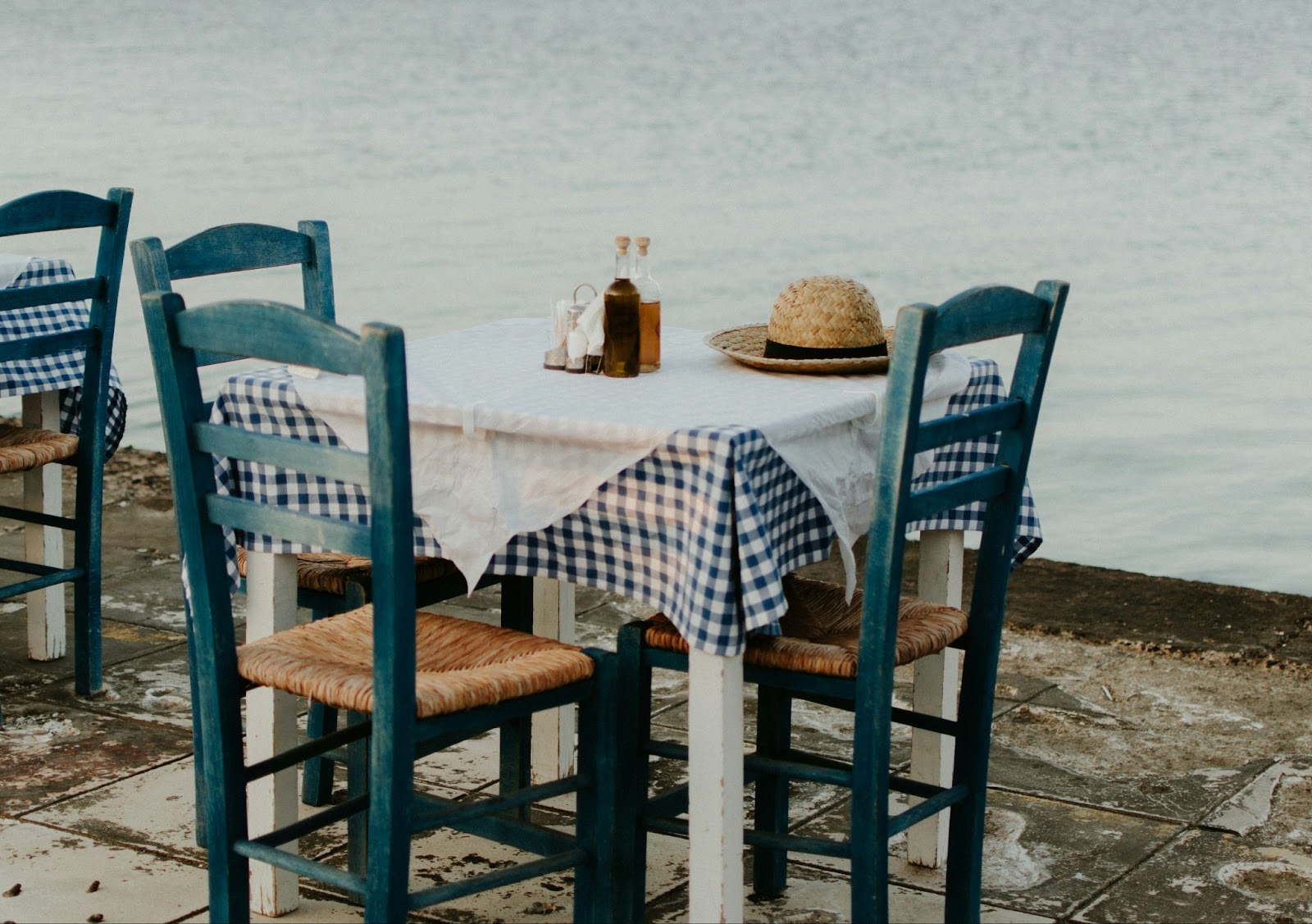 Learn why the seasonal food is a reason to visit in fall. This makes fall one of the best times to visit Greece. 
pictured: a outdoor table in Greece