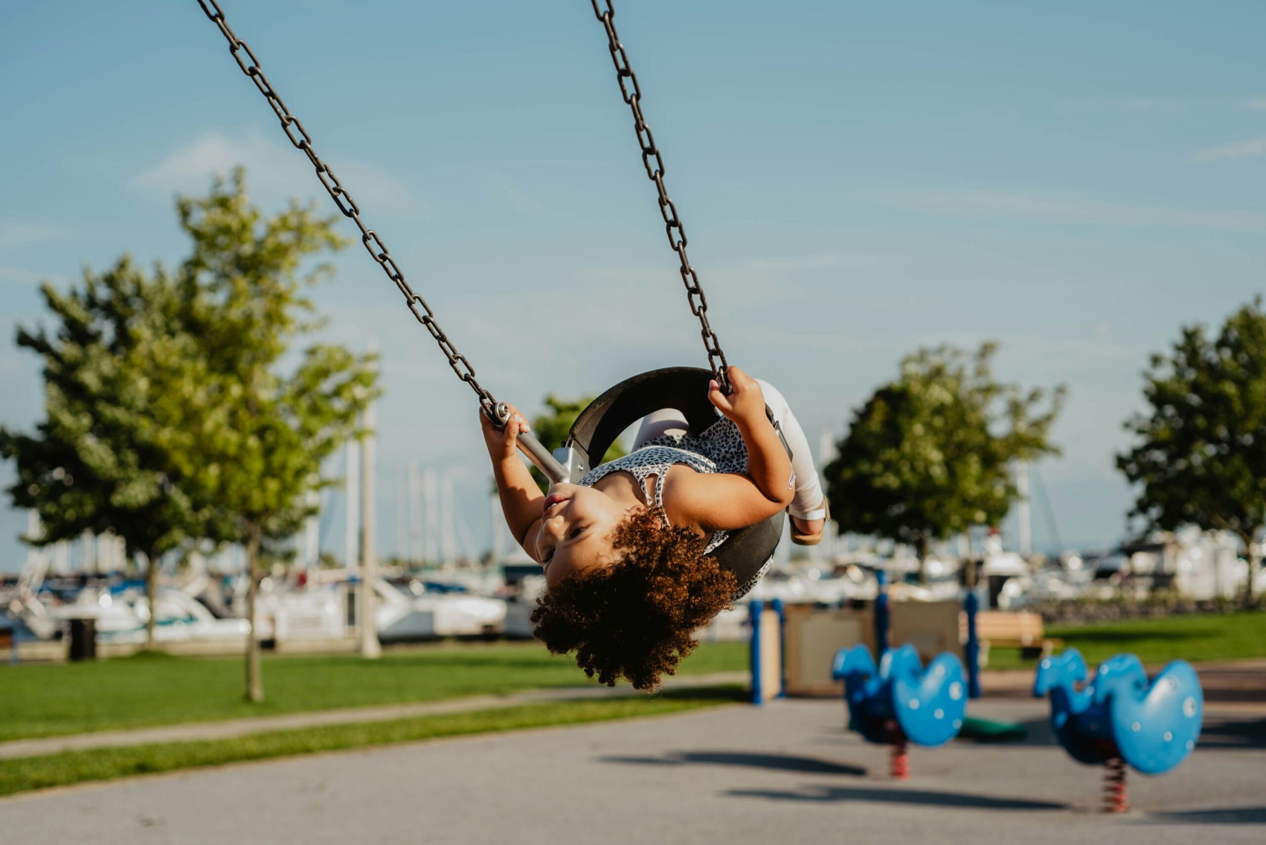 San Diego is family friendly during fall. 
Pictured: a child on the swings in San Diego